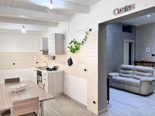 a kitchen and living room with a table and a couch at Lady Luxury Apartment in Bari