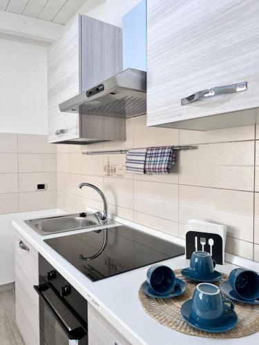 a kitchen with blue dishes sitting on a counter at Lady Luxury Apartment in Bari