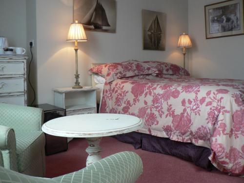 a bedroom with a bed and a table and a chair at 16 Franklin Bijou Boutique in Harrogate
