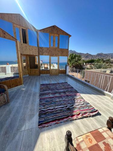 a large rug on the deck of a house at Panorama Lodge Nuweiba in Nuweiba