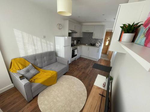 a living room with a couch and a kitchen at Studio in Reading 