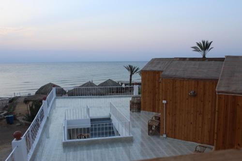 a large deck with a view of the ocean at Panorama Lodge Nuweiba in Nuweiba