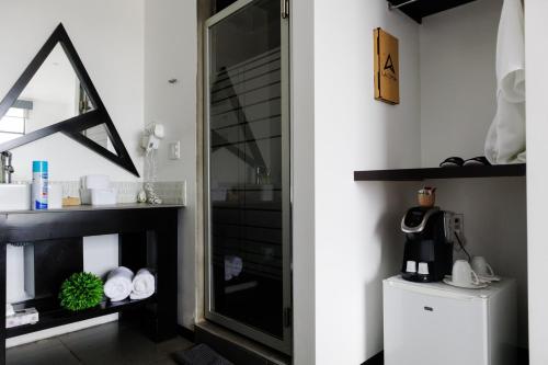 a bathroom with a mirror and a white refrigerator at La Cima del Valle in Valle de Guadalupe