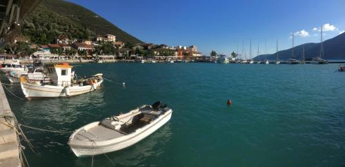 two boats are docked in a body of water at Orfeas Rooms in Vasiliki
