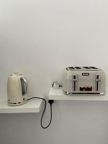 a toaster and toaster sitting on a shelf at Residência Azevedo in Câmara de Lobos