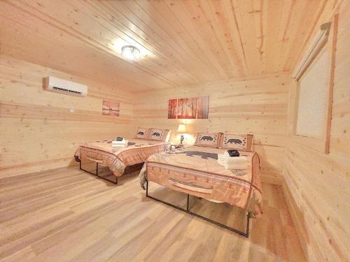 a log cabin with two beds in a room at Retreat on the Lake in Hiawassee