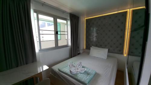 Ένα ή περισσότερα κρεβάτια σε δωμάτιο στο Silom Cityview Paradise Room