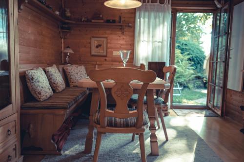 a dining room with a table and a couch at Chalet Spessart in Dammbach