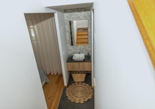 a bathroom with a sink and a mirror at Casa do Brasão in Lajes do Pico