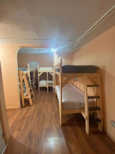 a small room with bunk beds and a table at Hoosville Hostel (Formerly The Everglades Hostel) in Florida City