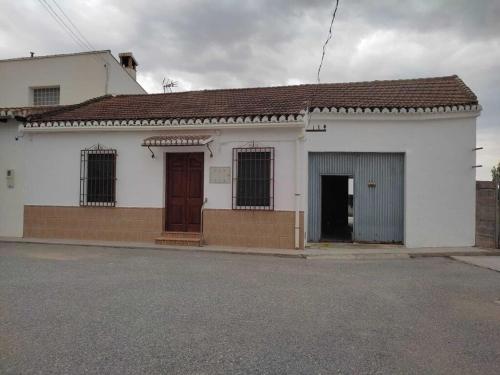 un edificio blanco con dos puertas en una calle en Casa Virginia entre mar y montaña, en La Paz