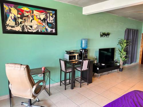 a living room with a table and a desk with a microwave at Brisa del Mar #6 in Brisas de Zicatela