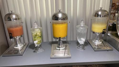 a table with three different types of drinks at Ville Celestine Condo Hotel e Eventos in Belo Horizonte