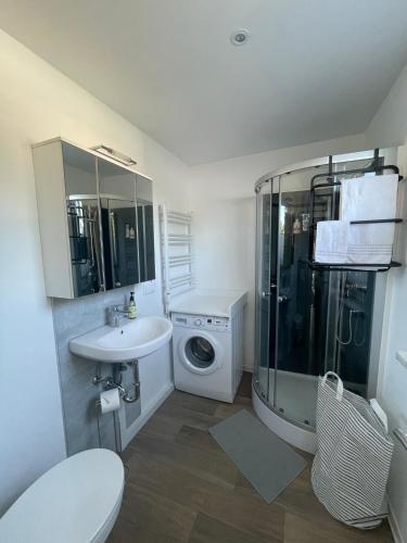 a bathroom with a sink and a washing machine at Ferienhaus Seekoje am Neustädter See in Neustadt-Glewe