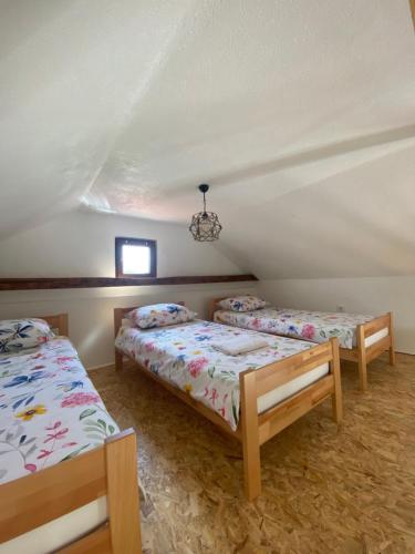 a bedroom with two beds in a attic at Hill House Emir in Bihać