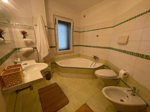 uma casa de banho com uma banheira, um WC e um lavatório. em Dimora Mirtilla - alloggio, max 4 posti letto. em Petacciato