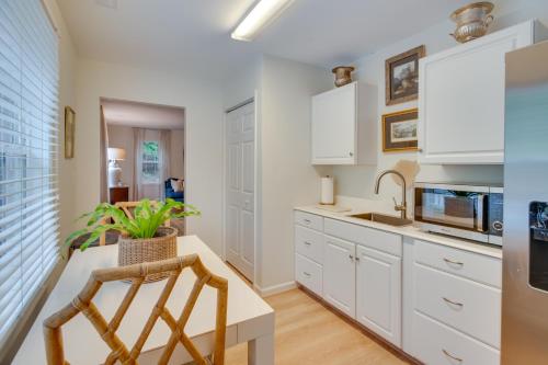 a kitchen with white cabinets and a table and chairs at Idyllic Cave Spring Studio with Patio and Fire Pit! in Cave Spring