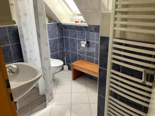 a bathroom with a sink and a toilet at Idyllische Dachgeschosswohnung in Wittenburg