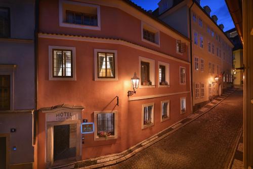an empty street in an old building at night at Hotel At the Green Grape in Prague