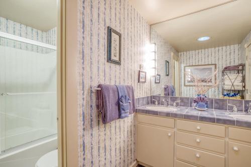 a bathroom with two sinks and a shower at Sandpiper Retreat in Waldport
