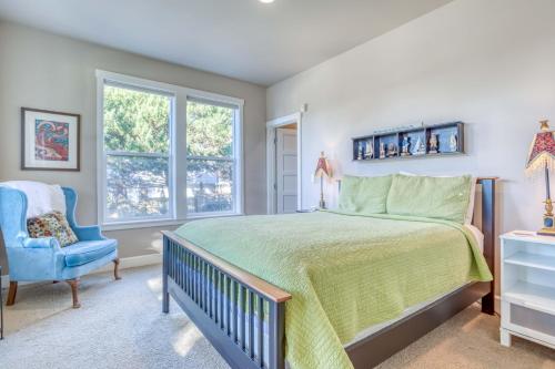 a bedroom with a bed and a blue chair at The Mermaid in Lincoln City