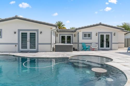 a swimming pool in front of a house at Miami House with Hot Pool-spa & Pool table L48 in Hialeah
