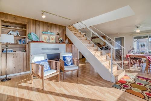 a living room with a staircase and a dining room at Star of the Sea in Lincoln City