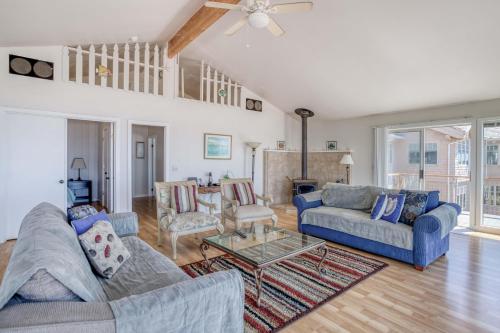 a living room with two couches and a table at Star of the Sea in Lincoln City