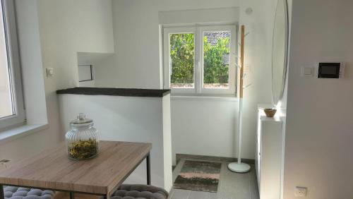 uma sala de estar com uma mesa de madeira e uma janela em Gîte le Séquoia em Sélestat
