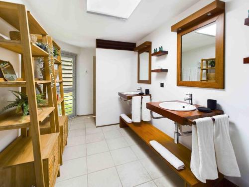 a bathroom with two sinks and a mirror at Villa Vi - St Barth in Saint Barthelemy