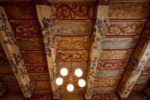 a ceiling of a building with a chandelier at At the Blue Lion & Parking Assistance in Prague