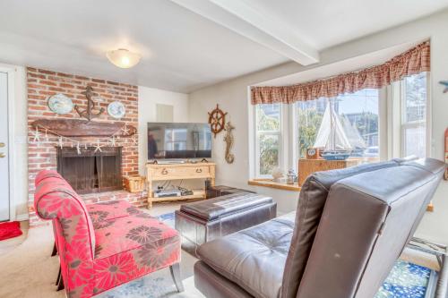 a living room with a couch and a fireplace at Siren Song in Lincoln City