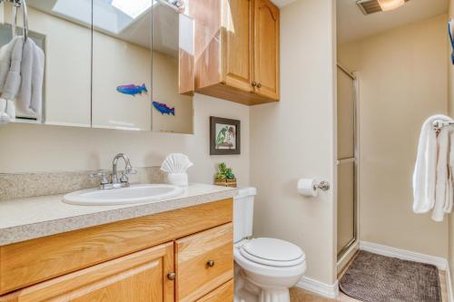 a bathroom with a toilet and a sink at Siren Song in Lincoln City