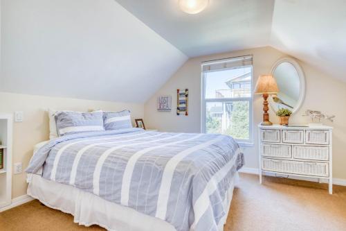 a white bedroom with a bed and a window at Siren Song in Lincoln City