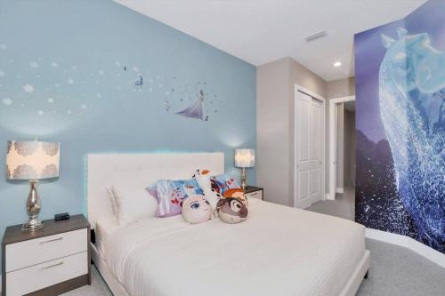a bedroom with a white bed with stuffed animals on it at New Awesome decorated dreamhouse in Orlando