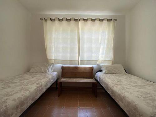 En eller flere senger på et rom på Casa en Oaxtepec