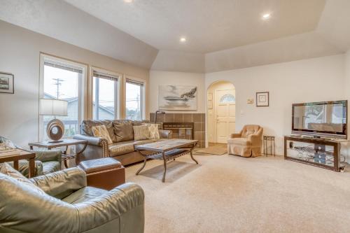 a living room with couches and a flat screen tv at Sea-Renity in Lincoln City