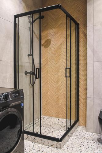 a shower with a glass door in a bathroom at Loft deLUX #nestapartamenty in Bielsko-Biała