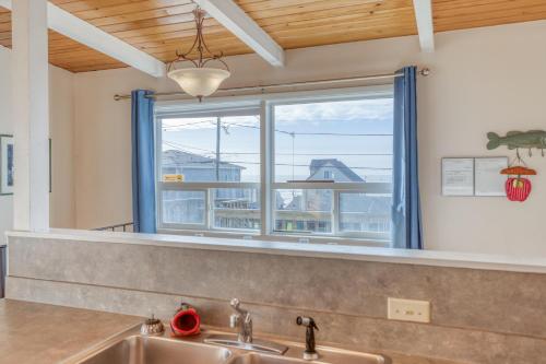 a kitchen with a sink and a large window at A Sea Breeze in Lincoln City