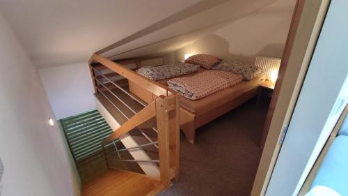 a small bedroom with a bunk bed and a staircase at Rodinný Apartmán Adléta in Horní Bečva