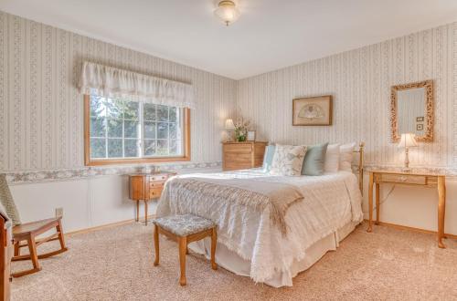 a bedroom with a bed and a chair and a window at Eleanor Edward Cottage by the Sea (MCA 148) in Manzanita