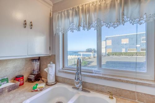 a kitchen counter with a sink and a window at Gardner Family House #2 in Depoe Bay