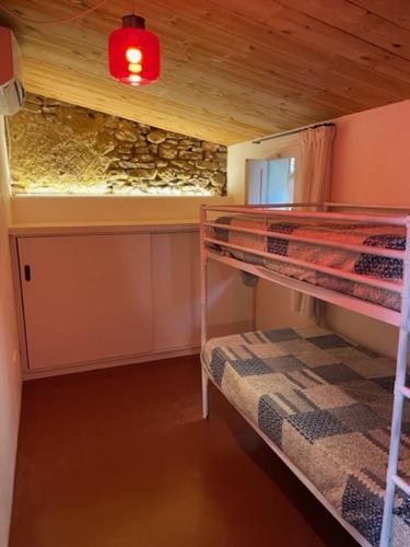 a room with two bunk beds and a stone wall at Mas blau new age in Girona