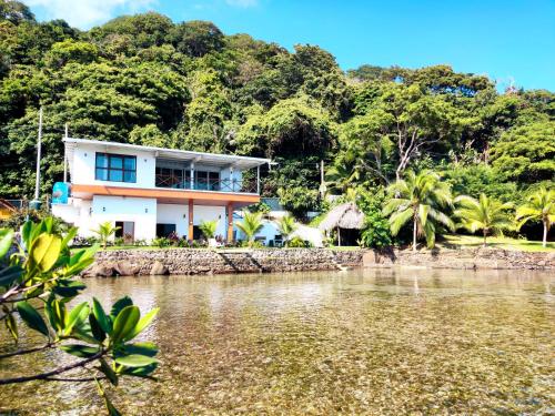 a house on the shore of a body of water at Kasakai Beachouse in Juan Gallego