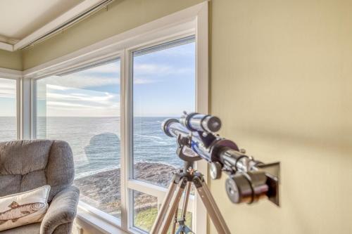 a camera on a tripod in front of a window at Gardner Family House #1 in Depoe Bay