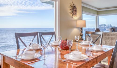 a dining room table with a view of the ocean at Gardner Family House #1 in Depoe Bay