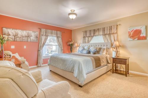 a bedroom with orange walls and a bed and a couch at Gardner Family House #1 in Depoe Bay