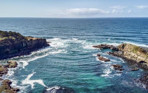 an aerial view of the ocean with rocks and water at Gardner Family House #1 in Depoe Bay