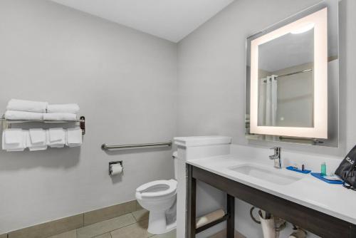 a bathroom with a toilet and a sink and a mirror at Holiday Inn Express Destin E - Commons Mall Area by IHG in Destin