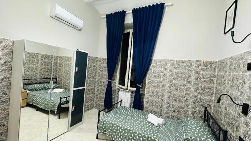 a room with two beds and a mirror at Soha's Holiday in Rome